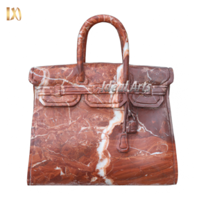 Hand-carved marble handbag sculpture in natural stone